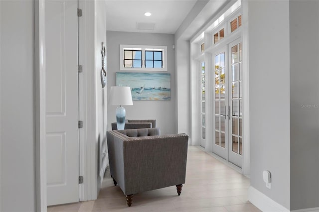 sitting room with recessed lighting, french doors, visible vents, and baseboards