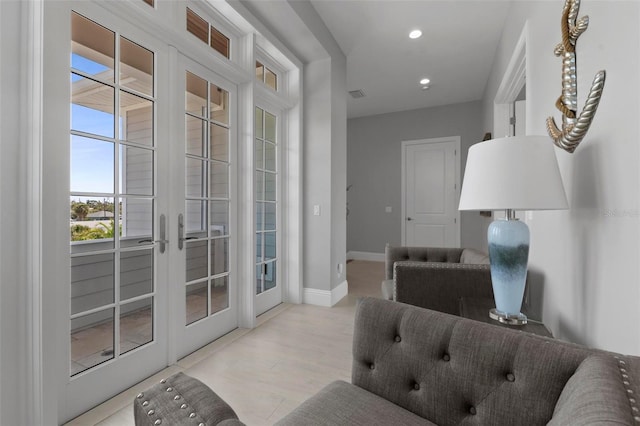 doorway featuring visible vents, baseboards, recessed lighting, french doors, and wood finished floors