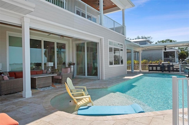 outdoor pool featuring a patio area, an outdoor living space, and ceiling fan