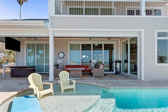 view of swimming pool with a patio, a hot tub, and an outdoor hangout area