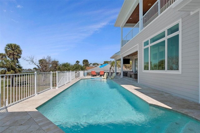 view of swimming pool with a patio, a fenced in pool, and fence