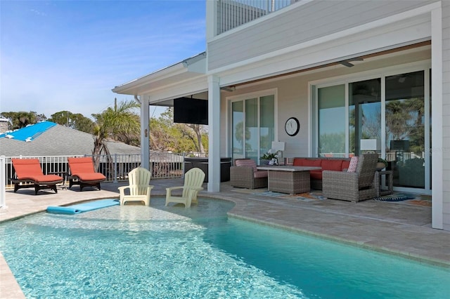 view of swimming pool featuring an outdoor living space, a fenced in pool, and a patio