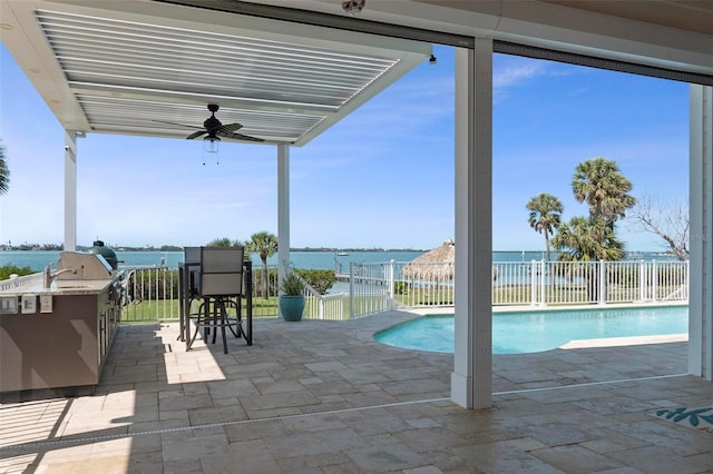 exterior space with a ceiling fan, fence, a fenced in pool, exterior kitchen, and a patio area