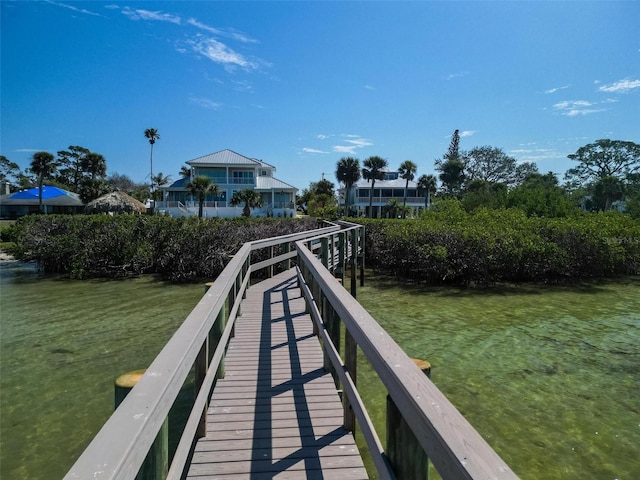 view of dock featuring a lawn