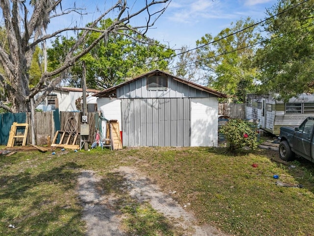 view of outdoor structure with an outbuilding and fence