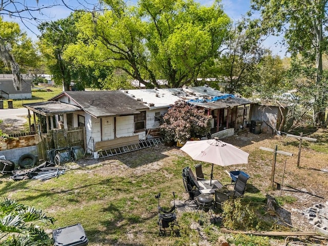 rear view of house with a yard