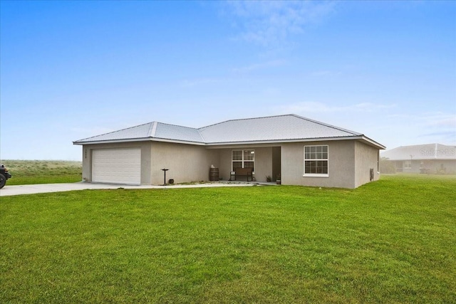 single story home with a front lawn, a garage, driveway, and stucco siding