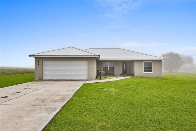 ranch-style house featuring concrete driveway, a front yard, stucco siding, metal roof, and a garage