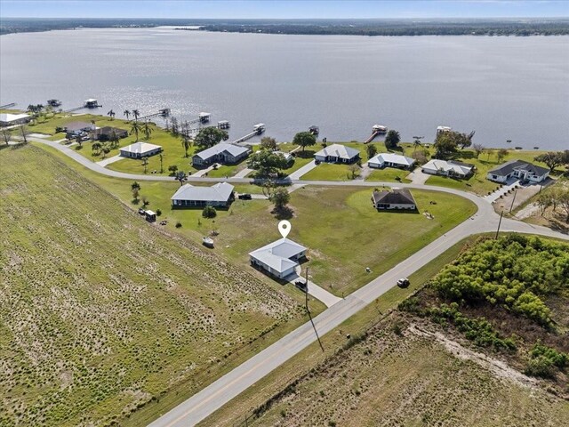 birds eye view of property featuring a residential view and a water view