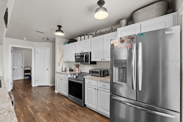 kitchen with visible vents, a toaster, white cabinets, stainless steel appliances, and dark wood-style flooring