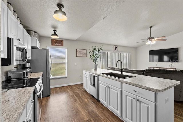 kitchen featuring dark wood-style floors, white cabinetry, stainless steel appliances, and a sink