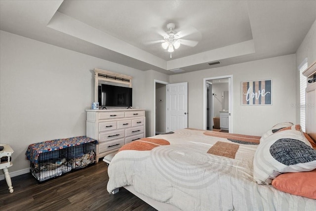 bedroom featuring baseboards, visible vents, ceiling fan, dark wood-type flooring, and a raised ceiling