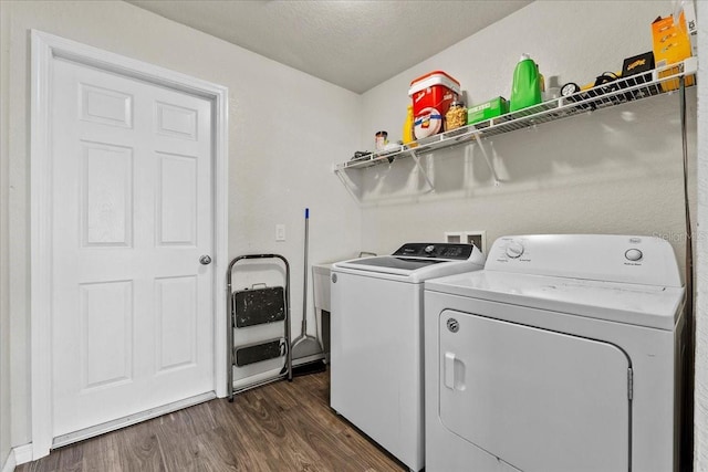 laundry room featuring washer and dryer, laundry area, dark wood finished floors, and a textured ceiling