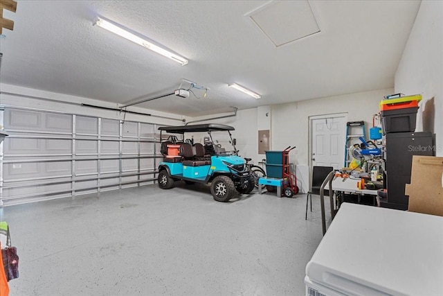 garage featuring electric panel and a garage door opener