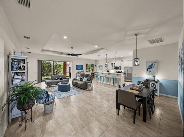 dining area featuring recessed lighting, visible vents, and a raised ceiling