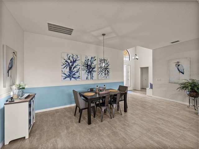 dining room with visible vents, baseboards, and an inviting chandelier