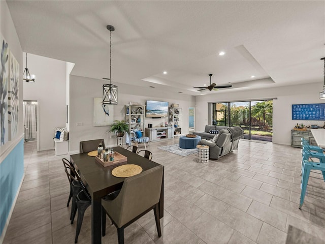 dining room featuring light tile patterned floors, recessed lighting, a raised ceiling, and a ceiling fan