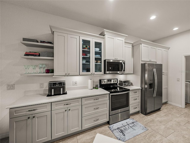 kitchen with open shelves, recessed lighting, stainless steel appliances, light countertops, and glass insert cabinets