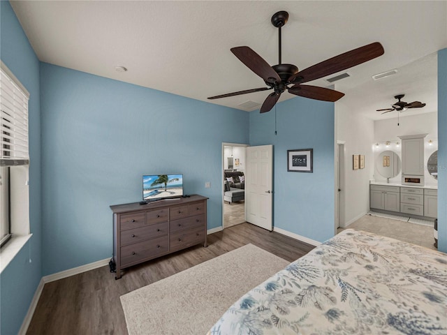 bedroom with visible vents, baseboards, and wood finished floors