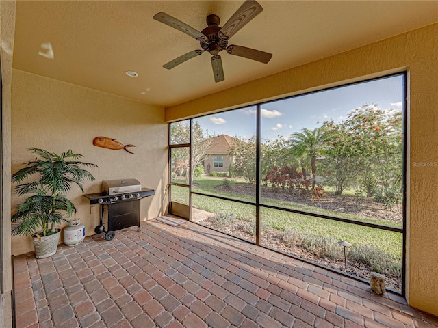 sunroom featuring ceiling fan