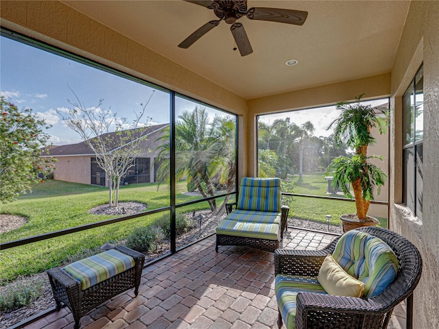 sunroom featuring ceiling fan