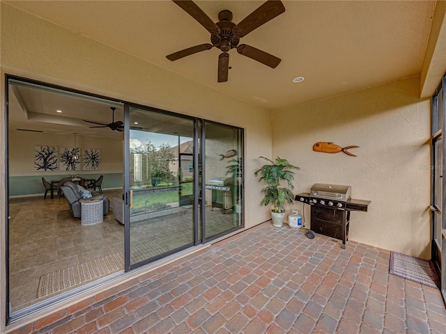 view of patio with area for grilling and ceiling fan