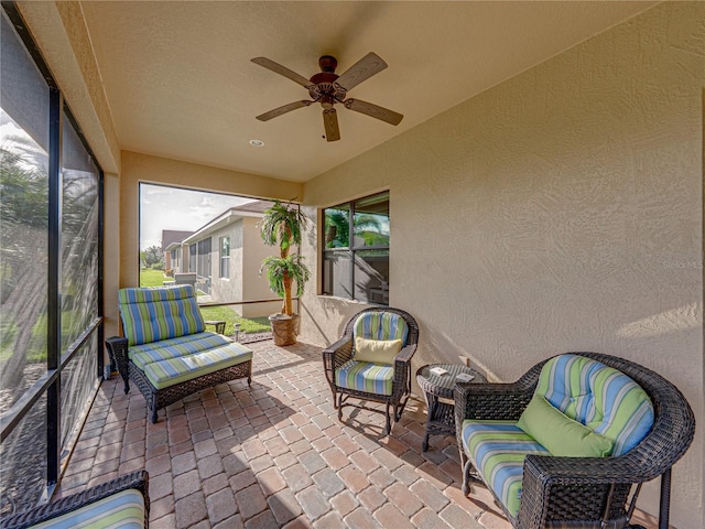 sunroom with ceiling fan