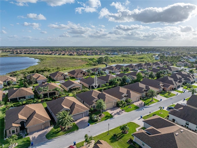 drone / aerial view with a residential view and a water view