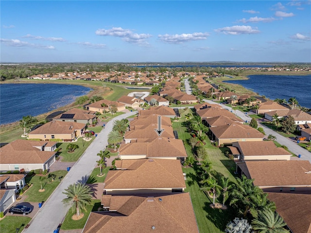 drone / aerial view with a residential view and a water view