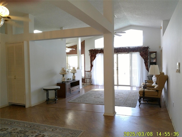 interior space featuring plenty of natural light, lofted ceiling, ceiling fan, and wood finished floors