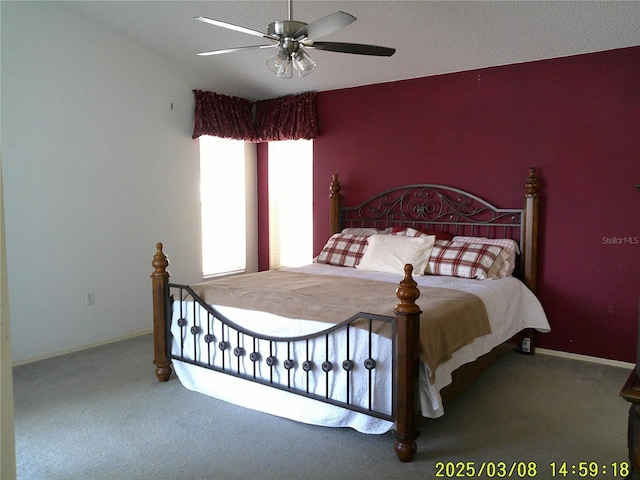 carpeted bedroom featuring baseboards and ceiling fan