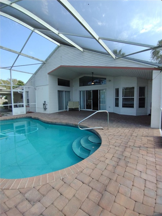 outdoor pool with ceiling fan, a patio, and a lanai