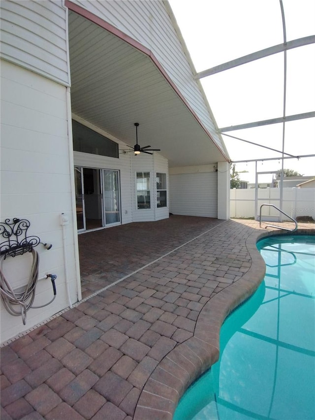 view of swimming pool with a fenced in pool, fence, a lanai, a patio area, and a ceiling fan