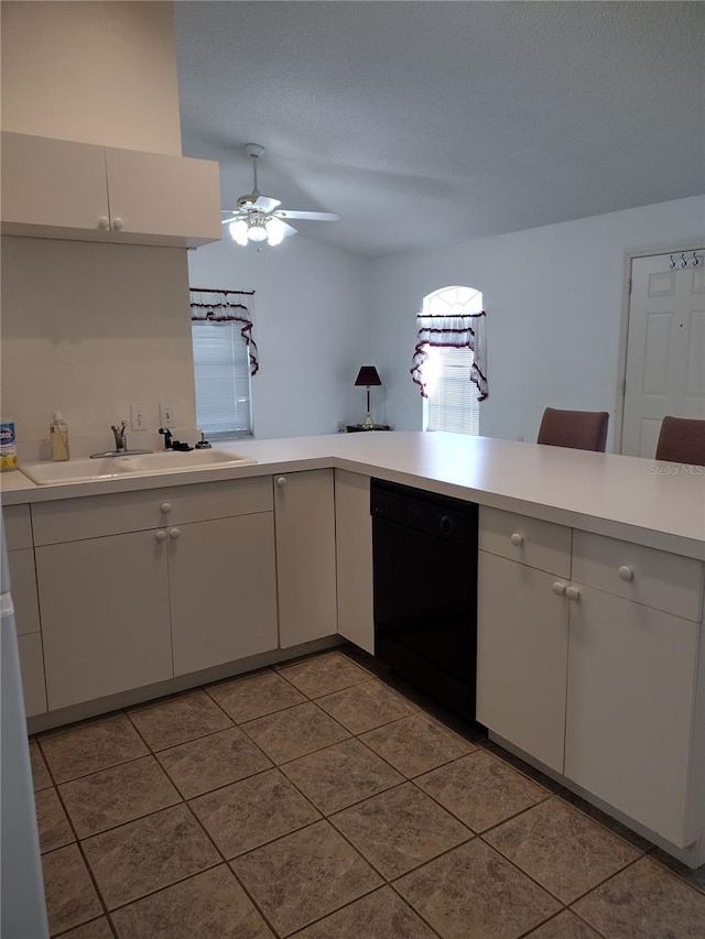 kitchen featuring dishwasher, light countertops, white cabinets, a textured ceiling, and a sink