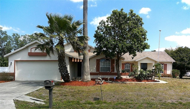 single story home with concrete driveway, a front yard, stucco siding, and an attached garage