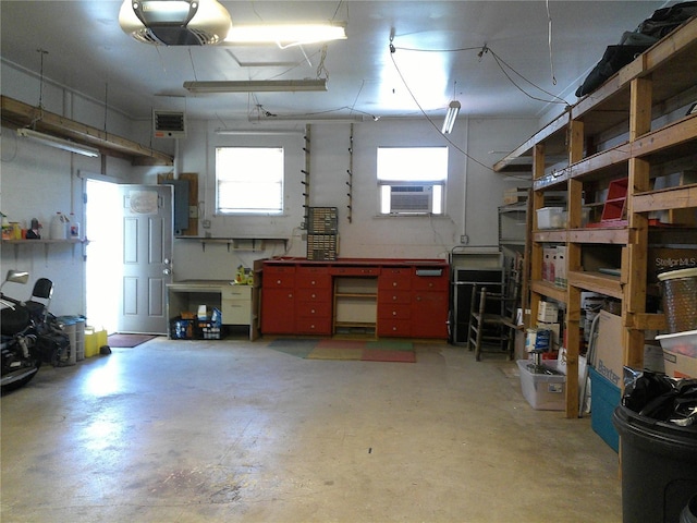 interior space featuring cooling unit, a workshop area, and a garage door opener