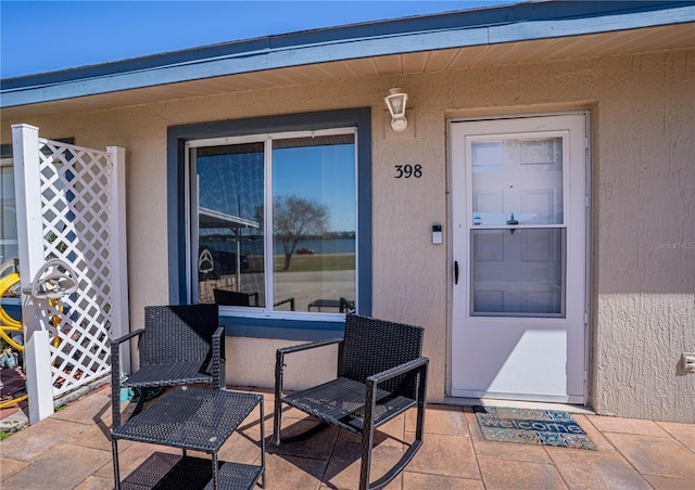 property entrance featuring stucco siding