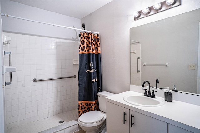 full bath featuring tiled shower, toilet, and vanity