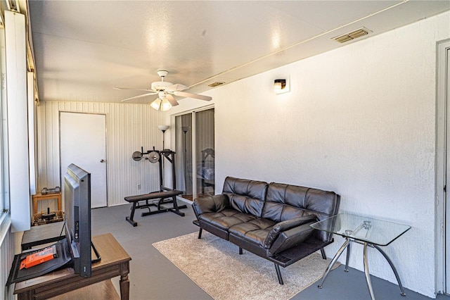 interior space with visible vents, concrete flooring, and ceiling fan