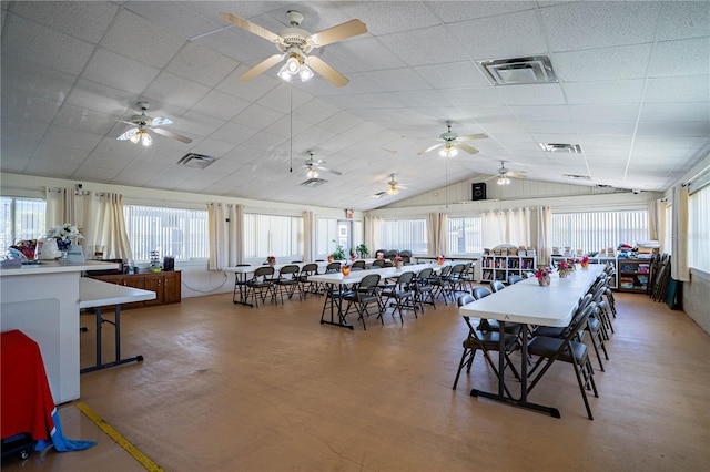 dining area with visible vents, a ceiling fan, lofted ceiling, and a drop ceiling