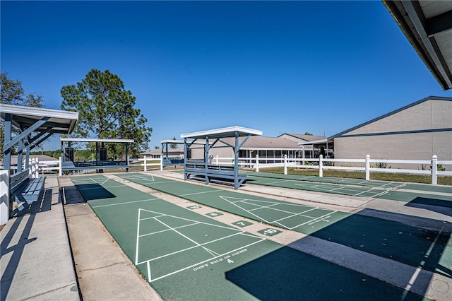 surrounding community featuring shuffleboard and fence