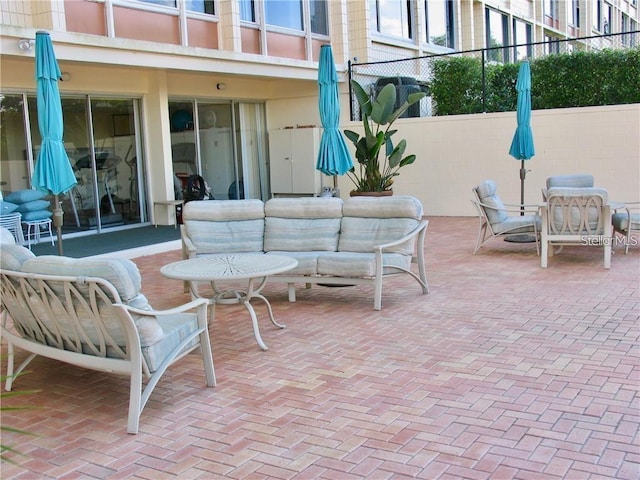 view of patio / terrace featuring an outdoor living space, outdoor dining space, and fence