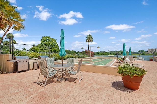 view of patio / terrace featuring shuffleboard, fence, and grilling area