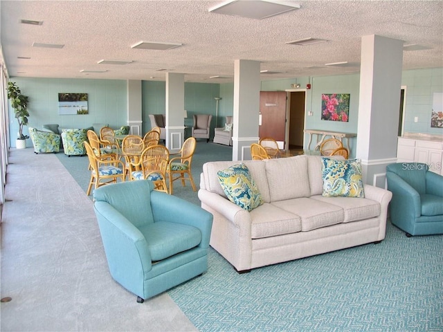 carpeted living area featuring visible vents and a textured ceiling