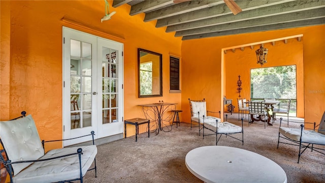 sitting room with beamed ceiling, french doors, and carpet