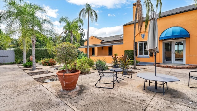 view of patio with french doors and fence