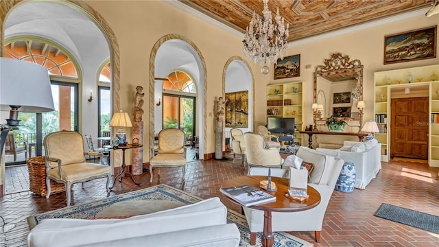 living area featuring a wealth of natural light, a towering ceiling, and ornamental molding