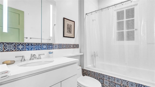 bathroom featuring vanity, toilet, and shower / tub combo with curtain