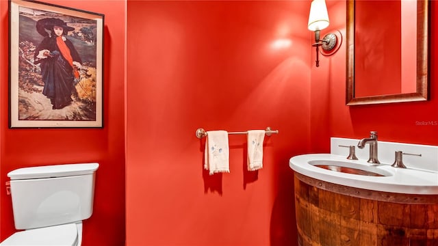 half bathroom featuring toilet and a sink