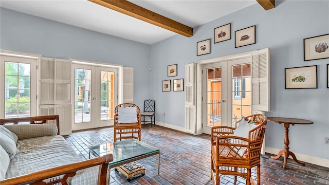 living area featuring beamed ceiling, brick floor, french doors, and baseboards